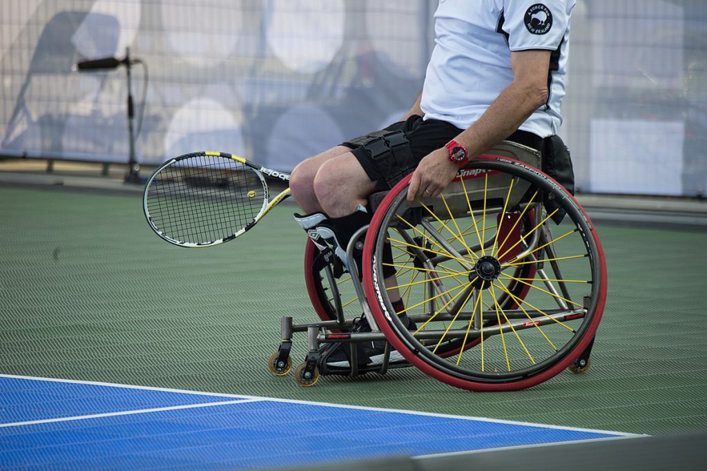 man playing wheelchair tennis