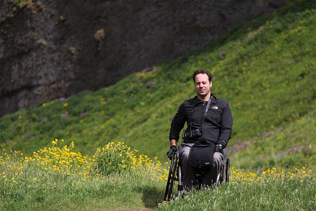Leandre in a meadow in his wheelchair