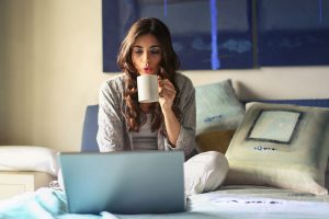 Woman with a coffee mug and laptop