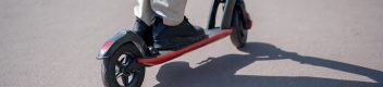close up of feet on a wheeled skateboard