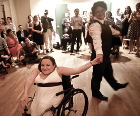 Bride using wheelchair and her partner on dancefloor