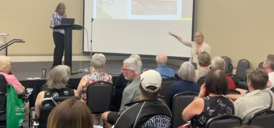 a woman making a presentation to an audience