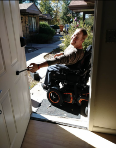 Man in wheelchair pulling door closed with T-Pull.