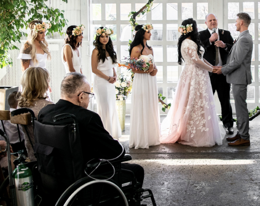 A man in a wheelchair watches his daughter get married.
