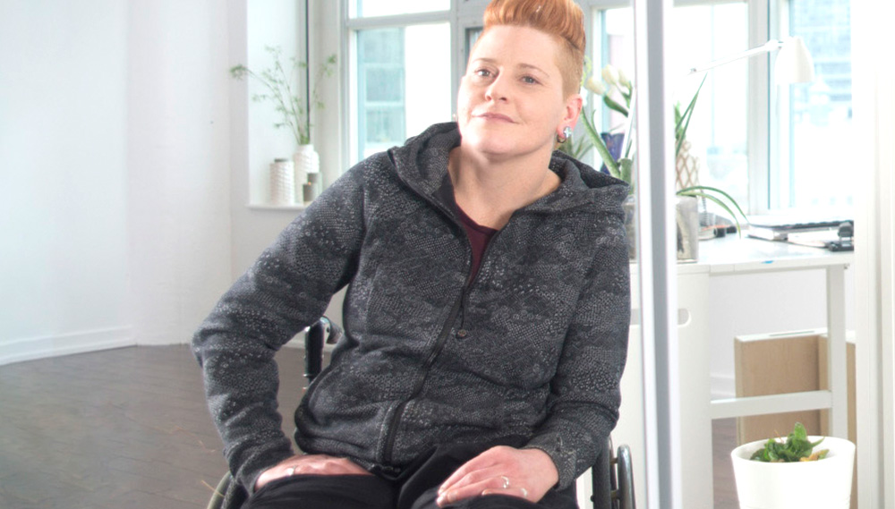 Woman sitting casually in wheelchair smiling