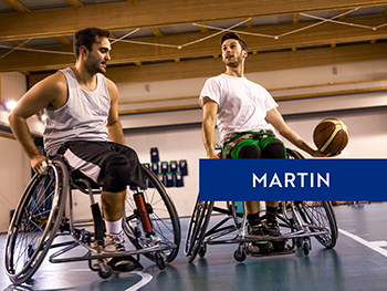Two young men playing wheelchair basketball.