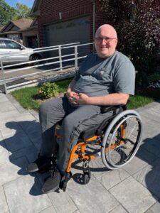 man smiling in manual wheelchair